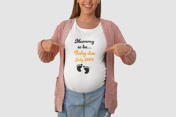 A white t-shirt with the words 'Mummy-to-Be' written in cursive, and below it, the option to add a due date month. The shirt is displayed against a neutral background."